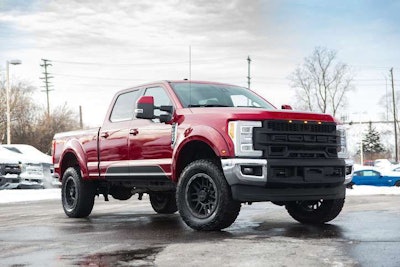 Red Roush F-250 parked side view