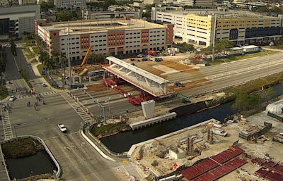 View of transporters moving the pedestrian bridge into place on the bridge piers. Photo: Florida International University, NTSB.