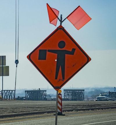 road workers ahead caution sign