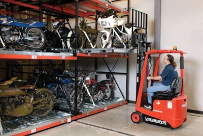 Mariotti forklift lowering a white motorcycle from a shelving unit
