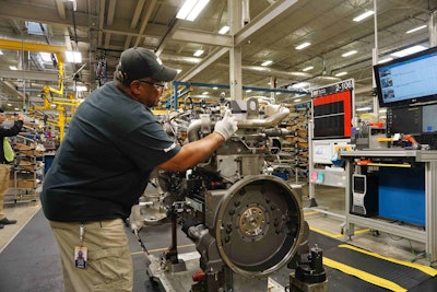 At each station, operators assemble each engine per on-screen instructions.