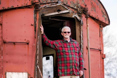 Clem Cooke stands in the doorway of the rail car that served as the offices of his company for 30 years. Photos: Wayne Grayson