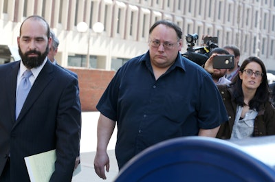 Kevin Otto, owner of Atlantic Drain Service, center, leaves Suffolk Superior Court with his attorney following his arraignment on manslaughter charges connected with a trench collapse that killed two of his employees on Thursday, February 23, 2017. Photo credit: Boston Herald.
