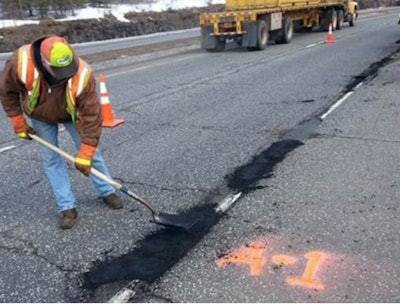 Roadway construction man filling a pothole