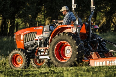 Farmer on Kubota tractor