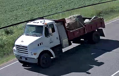 A 1,100-pound unsecured boulder fell out the back of this truck, killing two women in an oncoming car. Police say this photo, taken from a local refinery’s surveillance video, shows the truck just after the boulder tumbled out. PHOTO: Rosemount, Minn., Police Department.