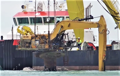 excavator pulled from ocean