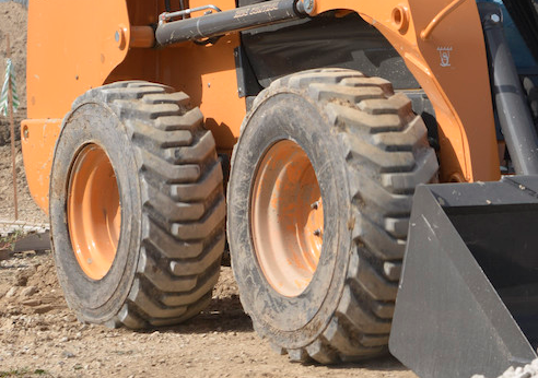 skid-steer skid steer close up tire bucket stock