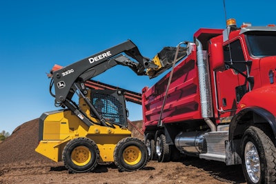 A 332G using the Boom Height Knockout feature to assist in loading a truck.
