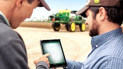 Two men using John Deere Ag Connected Support