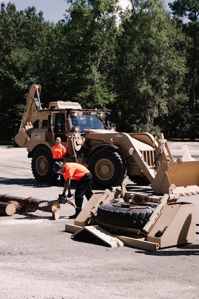 A demonstrator uses a chainsaw powered by the HMEE. Photo: Wayne Grayson