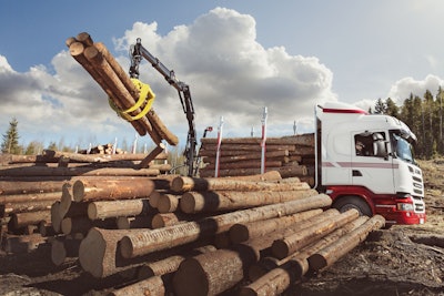Truck crane lifting logs