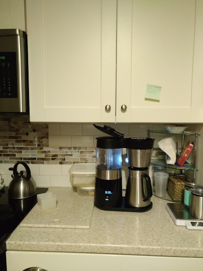 Coffee pot and cutting board on a kitchen countertop
