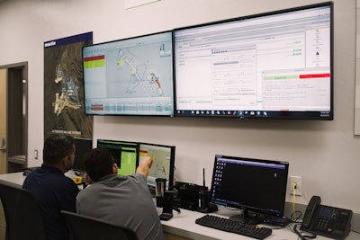 Operators discuss machine positioning within Central Control at Komatsu’s Arizona Proving Grounds.