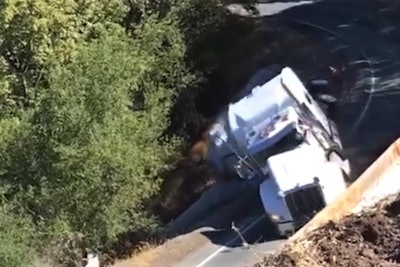 Semi-truck toppling off road