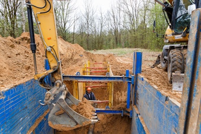 Construction worker in a trench box