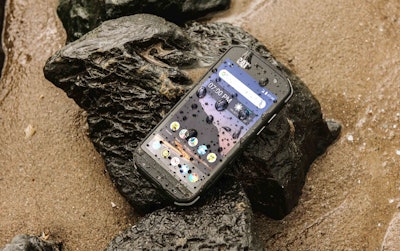 Caterpillar S48C Smartphone on a rock with water drops on the screen