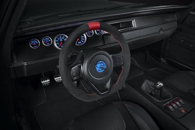 The interior of the 1968 Dodge “Super Charger” includes the unique “Hellephant” milled medallion applied on the upper door panels, a Dodge Viper steering wheel that also carries the “Hellephant” medallion at its center and a dash customized with a full array of Mopar gauges.