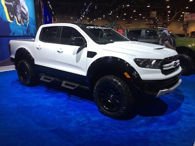 2019 Ford Ranger XLT SuperCrew 4×4 by AirDesign: 2.3-liter I4 EcoBoost engine; 10-speed automatic transmission; Ford Performance powertrain includes cat-back exhaust with Borla black chrome tips; BDS upper control arms; Fox 3-inch leveling kit with off-road shocks; Fuel Ripper 20- x 9-inch satin black wheels; 33-inch Nitto Ridge Grappler tires; Ford Accessories by Airdesign USA which includes door rocker moldings, front bumper lower center bar with bumper flares, fender vents, hood scoop, rear cab spoiler, rear tailgate spoiler, tailgate applique; Sherwin William custom white and black paint; Ford Performance Recovery Point