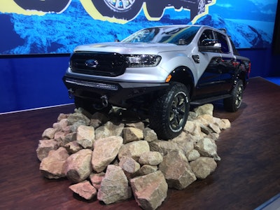 2019 Ranger Lariat 4×4 SuperCrew which Ford Performance says is a bold pre-runner that “highlights Ranger’s go anywhere, do-anything flexibility and capability that’s crucial for off-road teams to scout trails.” • 2.3-liter EcoBoost® I4 engine • 10-speed electronic automatic transmission • FX4 Off-Road Package • 3.73 electronic locking differential Powertrain • Ford Performance by Borla® cat-back exhaust Chassis • Ford Performance differential cover • BDS Suspension upper control arm kit • Fox three-inch leveling kit with off-road shocks • Ford Performance differential skid plate kit Wheels and Tires • Ford Performance wheels, 17 x 8.5 inches • BFGoodrich All-Terrain KO2 tires, 285/70-17 Exterior • Ford Accessories bed mat, spray-in bed liner, TOUCHLINK truck bed light by Lumen, SwingCase by UnderCover • Ford Performance white rock light kit by RIGID, plus RIGID bards-series PRO 40-inch curved light bar, E-Series PRO 40-inch light bar, D-Series amber spotlights, hood hinge-mounted off-road light kit with DSS-Series pro lights and white RIGID Radiance Plus Pods backlight • Addictive Desert Designs Desert Racer front bumper with integrated skid plate and rear bumper, chase rack and illuminated Rock Slider side steps • Kay Automotive Graphics KPMF Premium Air Release silver graphics kit • Two 3.5-gallon Rotopax® FuelpaX with FuelpaX Deluxe Pack mount Interior Ford Performance by WARN® Industries recovery kit includes storage bag, 22-foot by two-inch blue recovery strap rated to 14,400 pounds, winching gloves and a ¾-inch D-shackle rated to 18,000 pounds Ford Accessories all-weather floor liners plus front and rear-facing cameras with DVR by AMP Global
