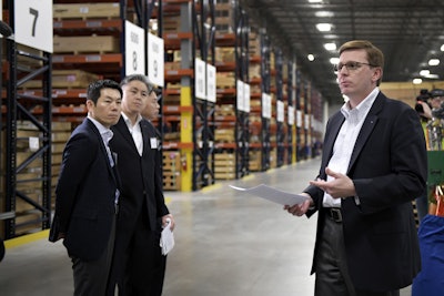 Director of Parts Clay Caldwell leads a tour of the new center. From left are Executive Vice President JS Ahn and CEO Edward Song.