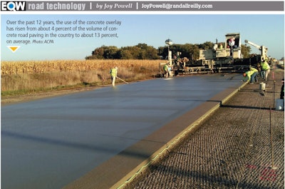 Construction crew pouring concrete overlay on road