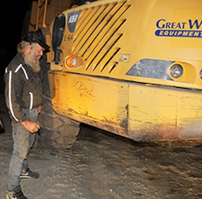Tony Beet of Gold Rush autographs a hauler that Volvo CE donated to a high school to help train future equipment operators.
