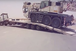 Crane shoves truck trailer