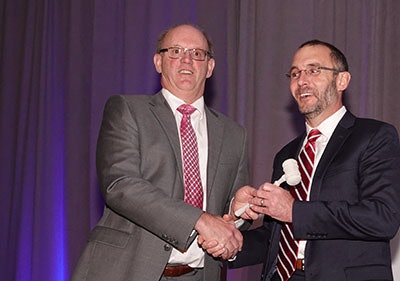 Chuck Niederriter (left), 2018 Chairman ACPA Board of Directors and CEO of Golden Triangle Construction Co., passes the gavel to 2019 Chairman ACPA Board of Directors, James W. Mack, director of Market Development-Commercial Strategy, CEMEX.