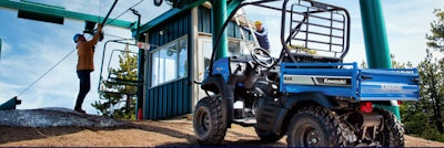Kawasaki 4x4 parked at construction site with 2 workers