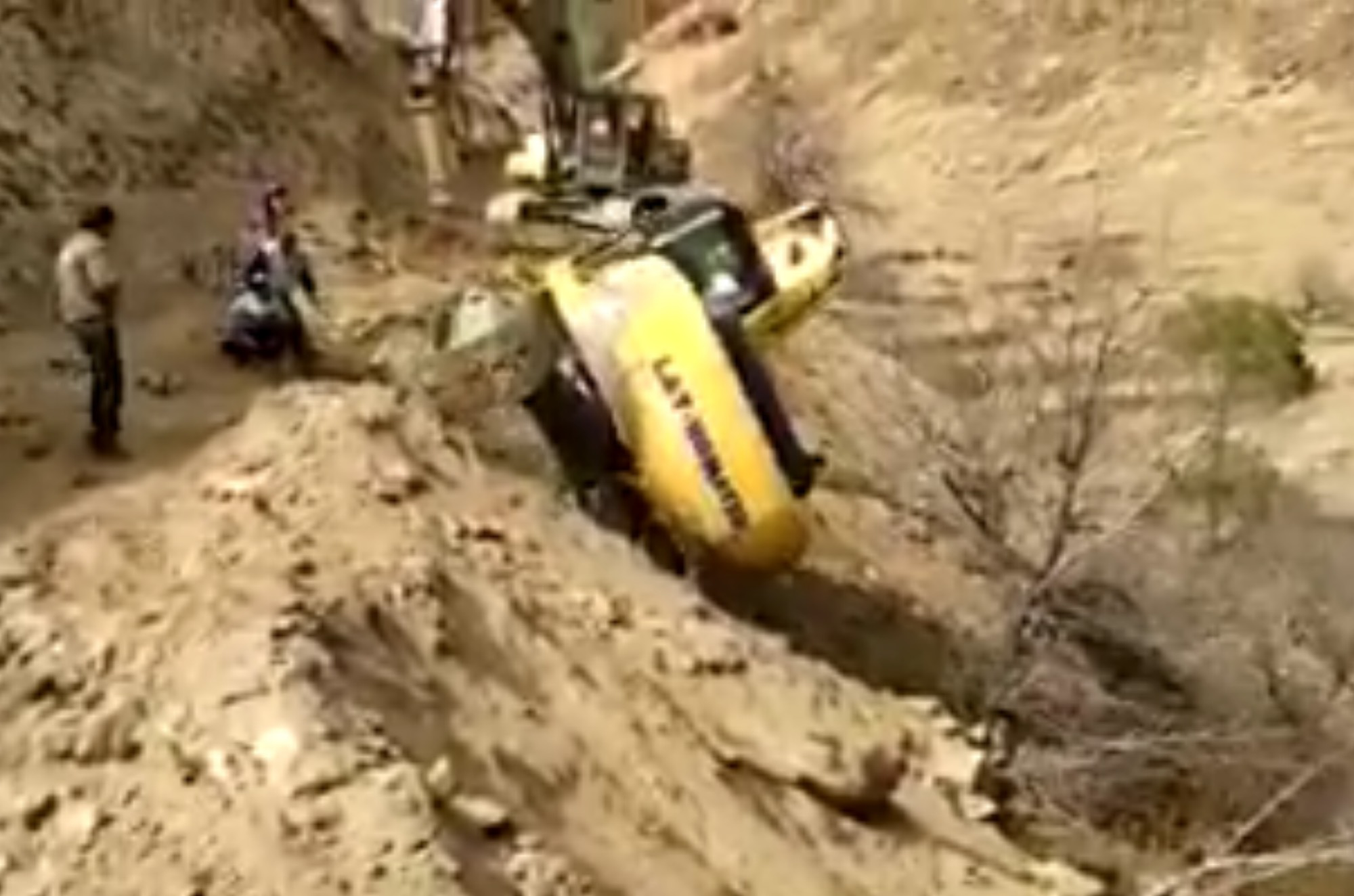 Excavator tumbles down long hill