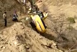 Excavator tumbles down long hill
