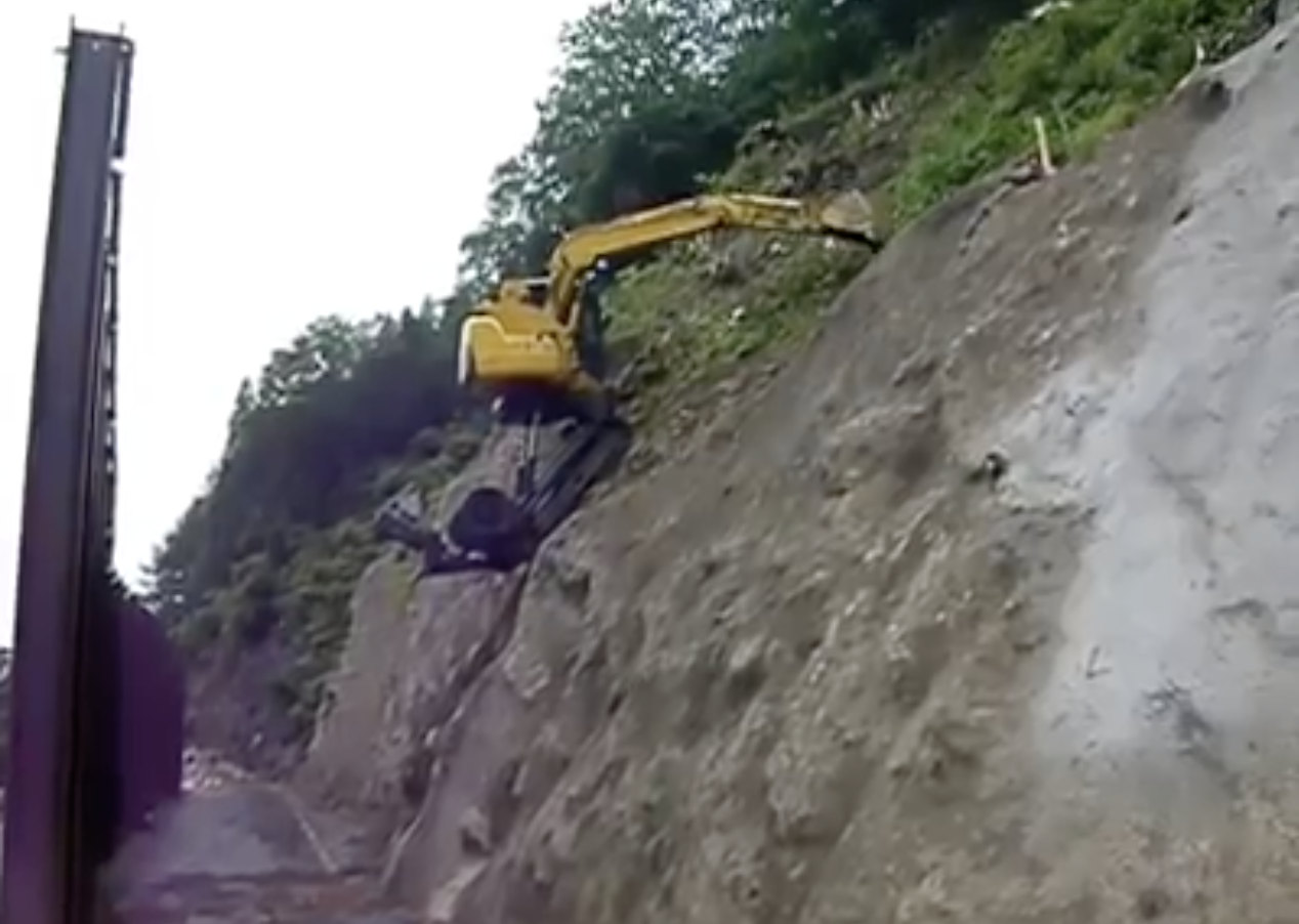 Excavator climbing rock face