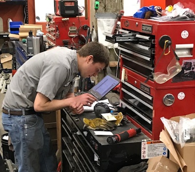 Derek Dassel, who’s been with Berry Companies’ White Star Machinery division for 4.5 years, tackles a machine fix with an open laptop.