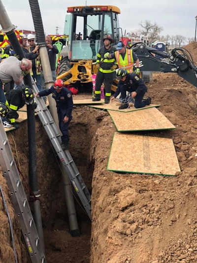 Responders use a vacuum to remove loose dirt during a trench-collapse rescue attempt April 16 in Windsor, Colorado. The trench was shored so responders could enter the trench with small shovels and buckets to dig out the two buried workers. “Since the ground is both unstable and compacted around the trapped workers, extreme caution to cause no further harm to those trapped, nor the emergency response personnel on scene, was paramount to the operation,” according to the Windsor Severance Fire Rescue department. Photo credit: Windsor Severance Fire Rescue