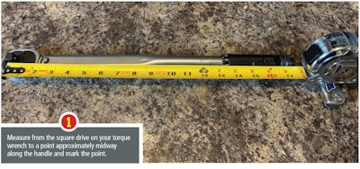 Torque wrench being measured with a yellow tape measure