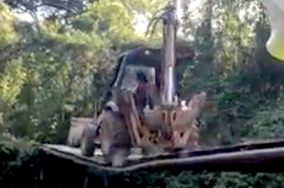 Backhoe on breaking bridge