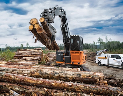 Hitachi forestry equipment picking up logs