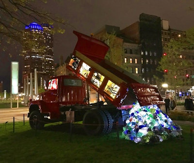 Red dump truck on display as public art with stained glass