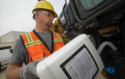 Pouring DEF — Diesel Exhaust Fluid into equipment
