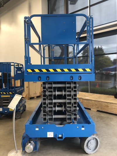 The black and yellow tape on this Genie GS-4655 indicates that it is ANSI-compliant. Such tape on the platform is required under the new ANSI standards to show which machines are compliant. Lifts built before the standards take effect are grandfathered in to the current standards.