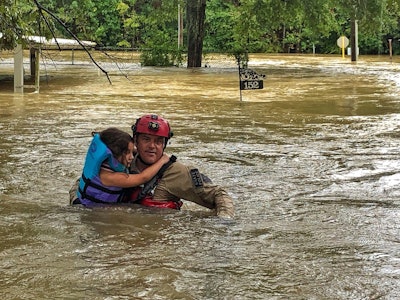 A Texas game warden rescues a girl from her flooded home. Photo: Texas Parks and Wildlife Department
