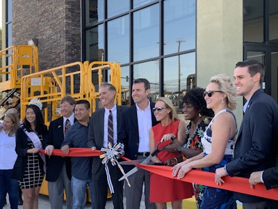 Mayor Acquanetta Warren (third from right) and Alice Bamford join JCB executives and local dignitaries to cut the ribbon to commemorate the opening of the new SoCal JCB facility in Fontana, California.