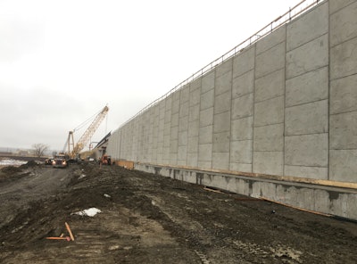A permanent wall of precast concrete anchored by more than 100 caissons drilled into bedrock is built beside the Geofoam blocks to stabilize them. Photo credit: Colorado DOT