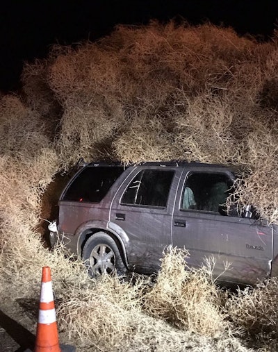 An SUV is covered during windstorm that caused tumbleweeds to invade Washington highway on New Year’s Eve. Photo credit: Washington DOT East District