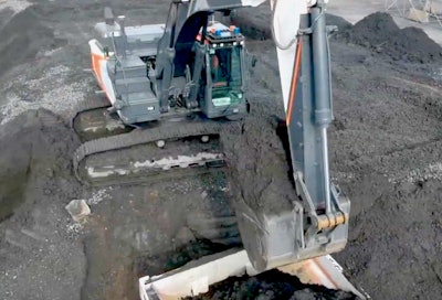 An unmanned, autonomously operating Doosan Concept X excavator loads a truck.