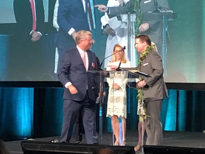 Outgoing chairman John Hodges, left, congratulates Jay Winford, the new chairman of the National Asphalt Pavement Association, during NAPA’s annual conference in Hawaii.