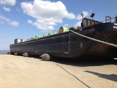 The big barges are rolled up on airbags at the end of the season and rolled back out to sea when the ice thaws.