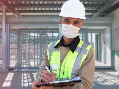 construction zone, man with hard hat clipboard, and mask