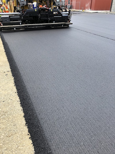 A Shilling Construction paving crew uses the Oxclaw screed plate system on a recent job in Kansas. Travis Shilling says the pavement is smooth, and the lines are just shadows that are more apparent on cloudy days.